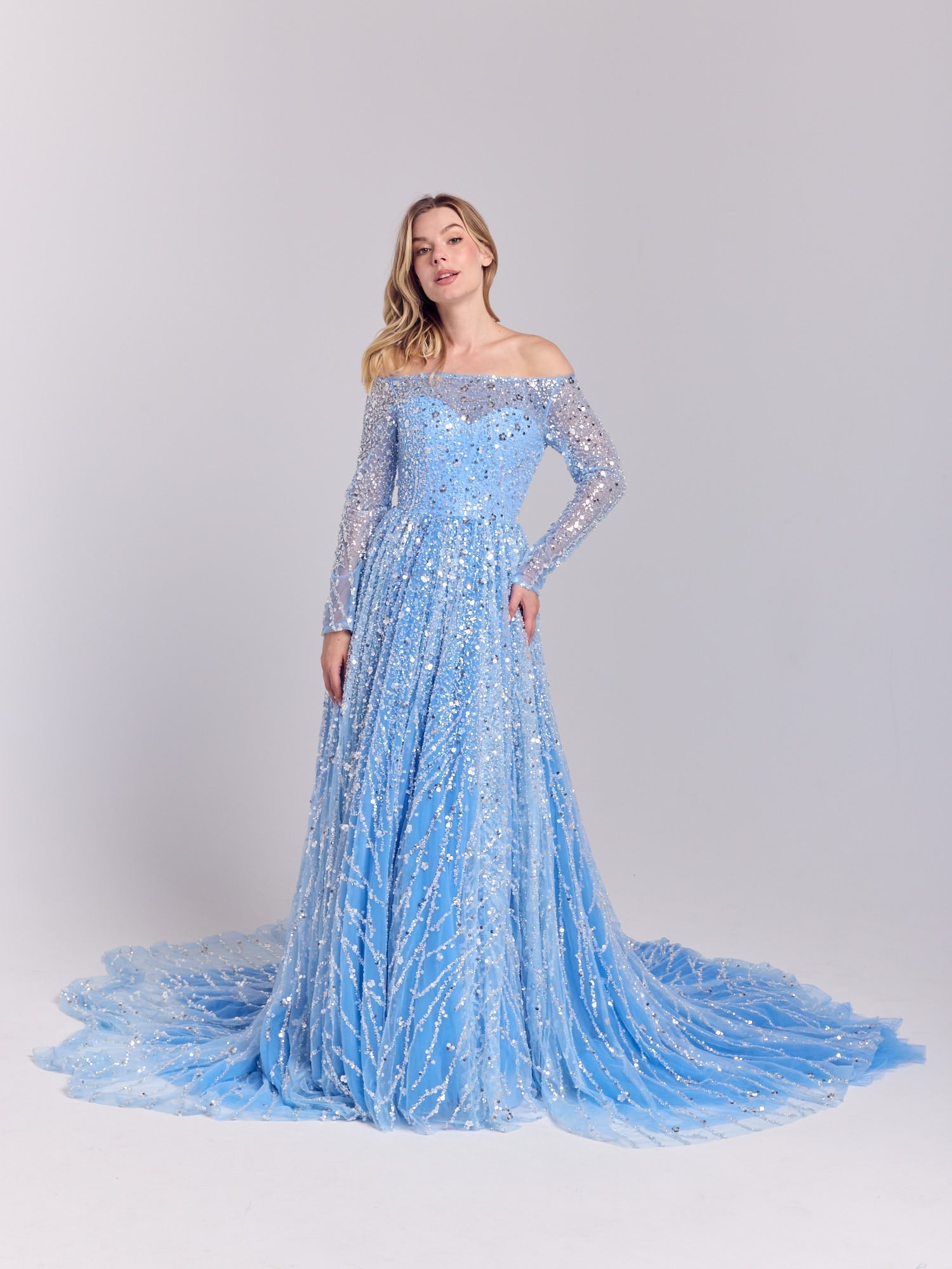 Ice blue off-the-shoulder gown with sequins and a flowing train from La Belle Élégance SS 2026 — perfect for evening wear or a modern bridal look